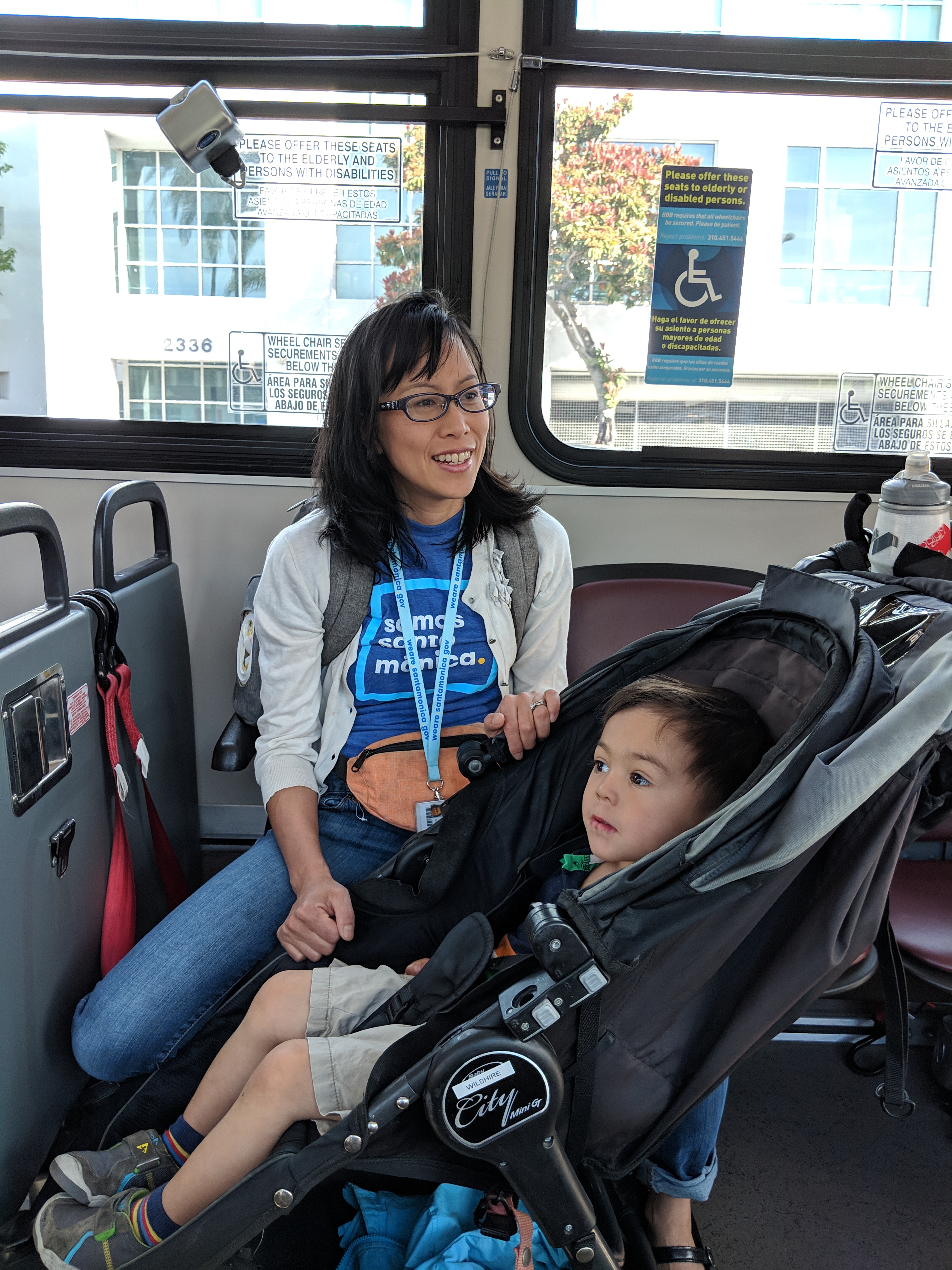 Customer is shown holding onto her stroller while the bus is in motion.