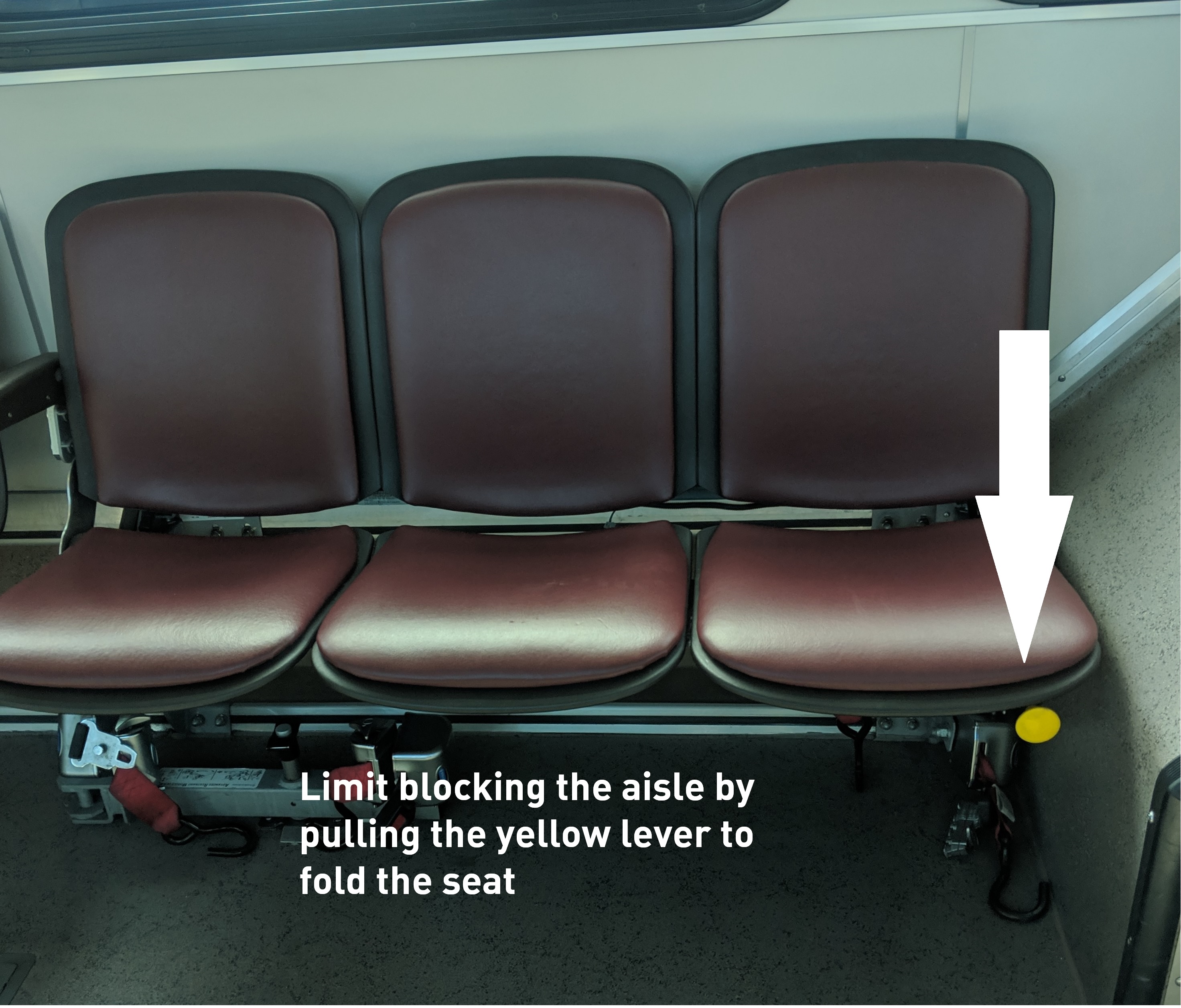 Graphic showing where to pull lever to fold the seat on the bus