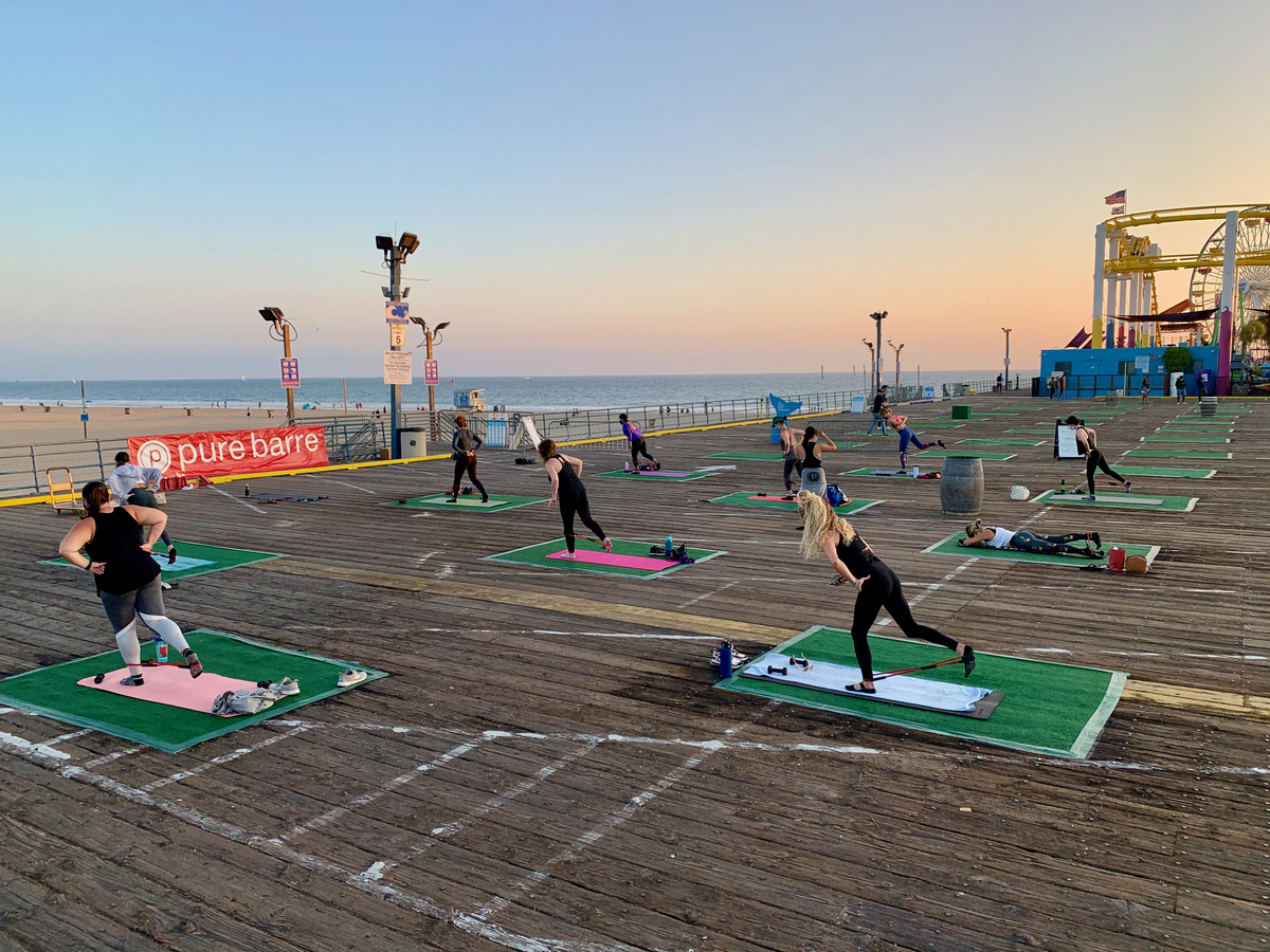 Pure Barre yoga practitioners socially distanced on the Santa Monica Pier